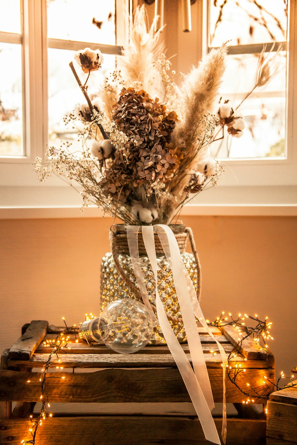 white flowers in clear glass vase