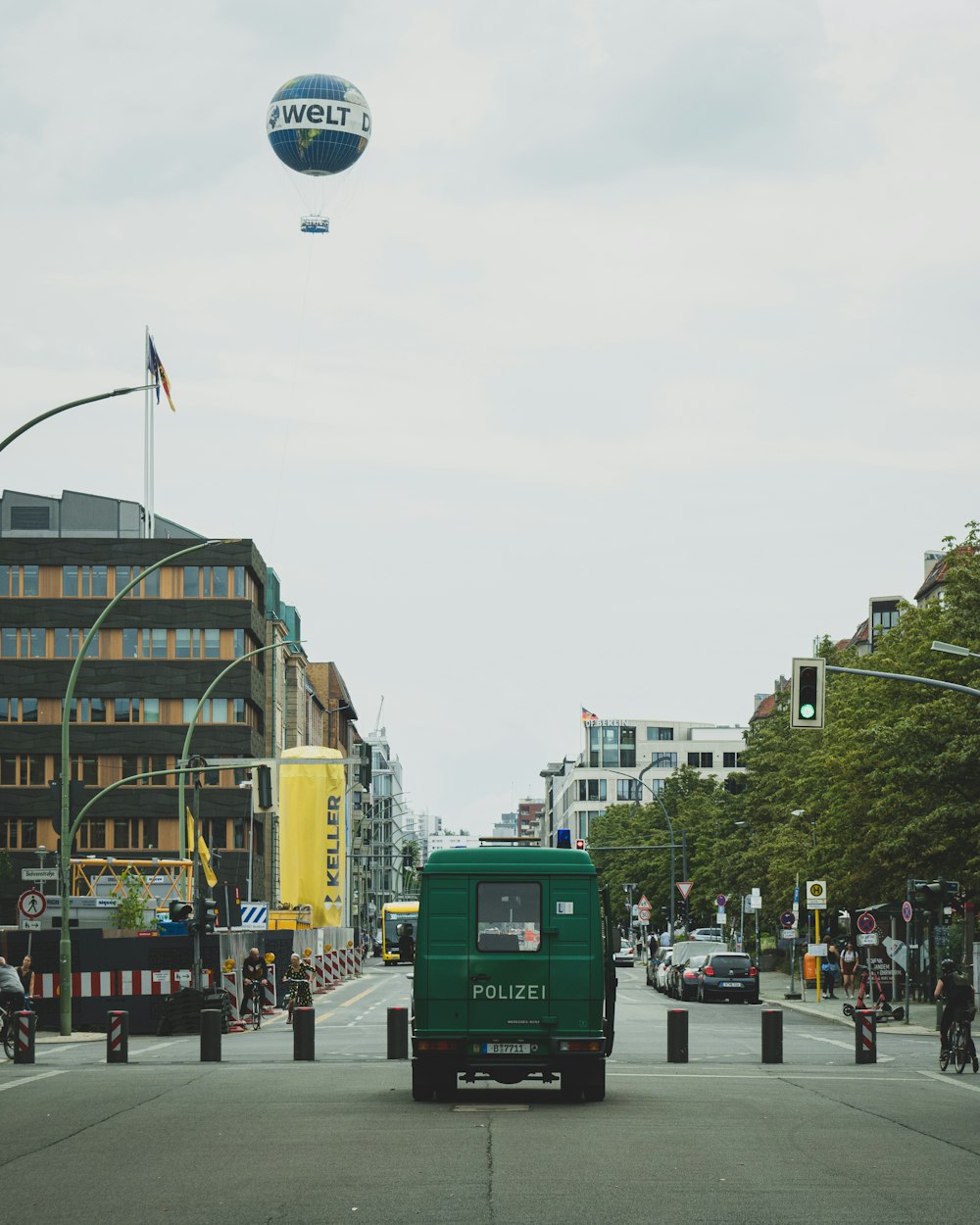 green bus on road during daytime