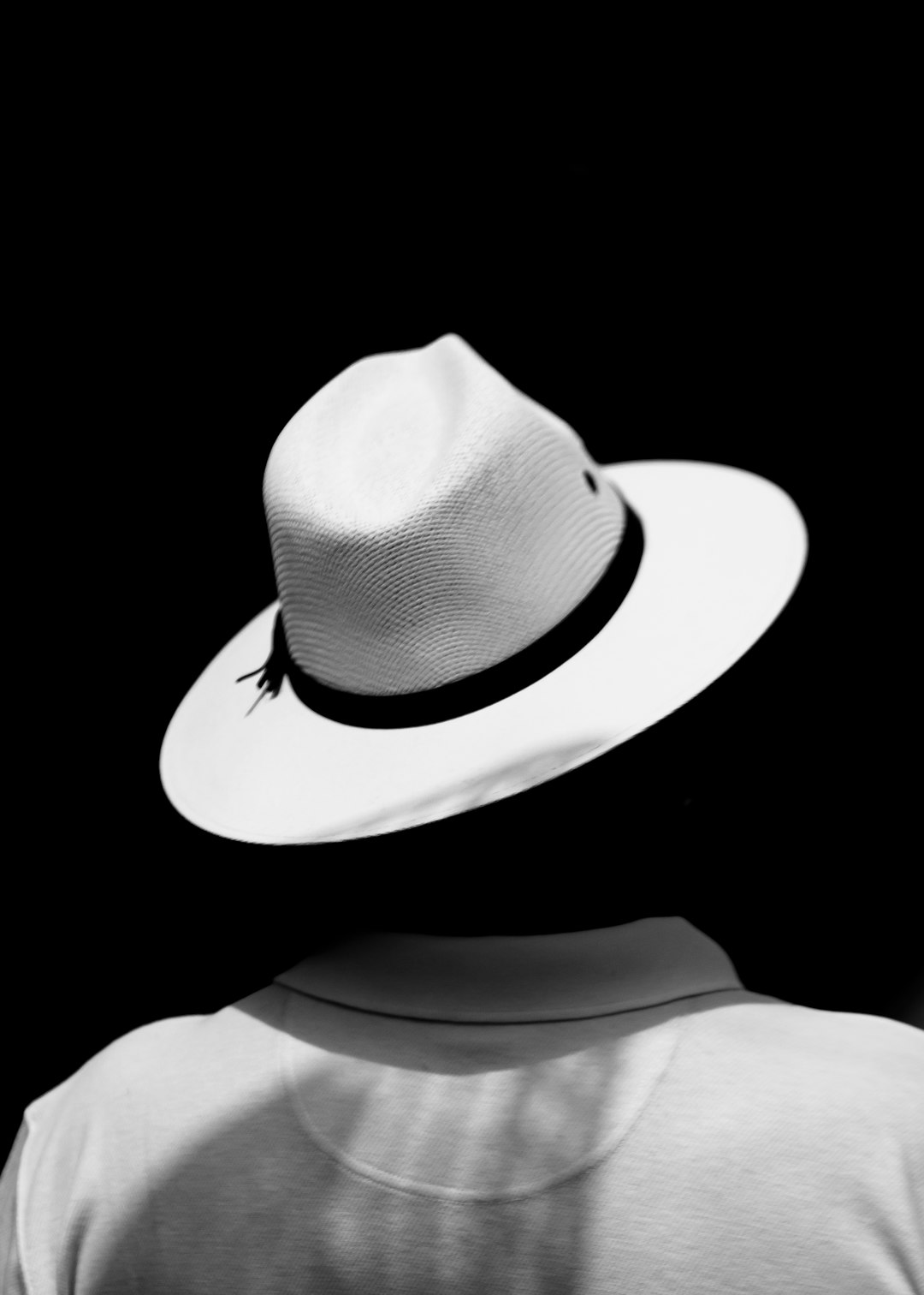 white fedora hat on black background