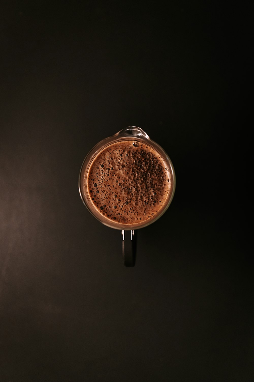 brown and white ceramic mug with coffee