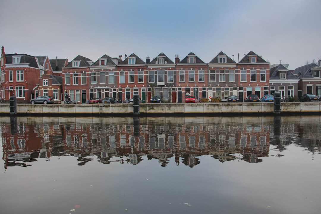 white and red concrete building near body of water during daytime