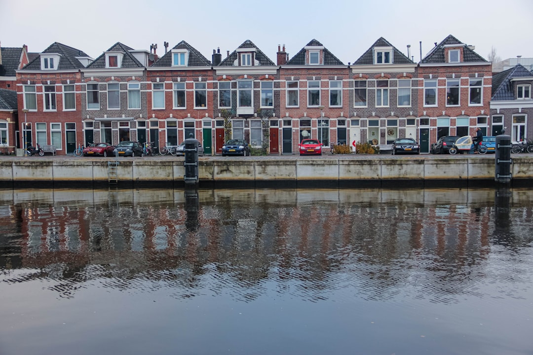 white and brown concrete building near body of water during daytime