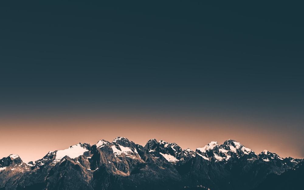 snow covered mountain during night time