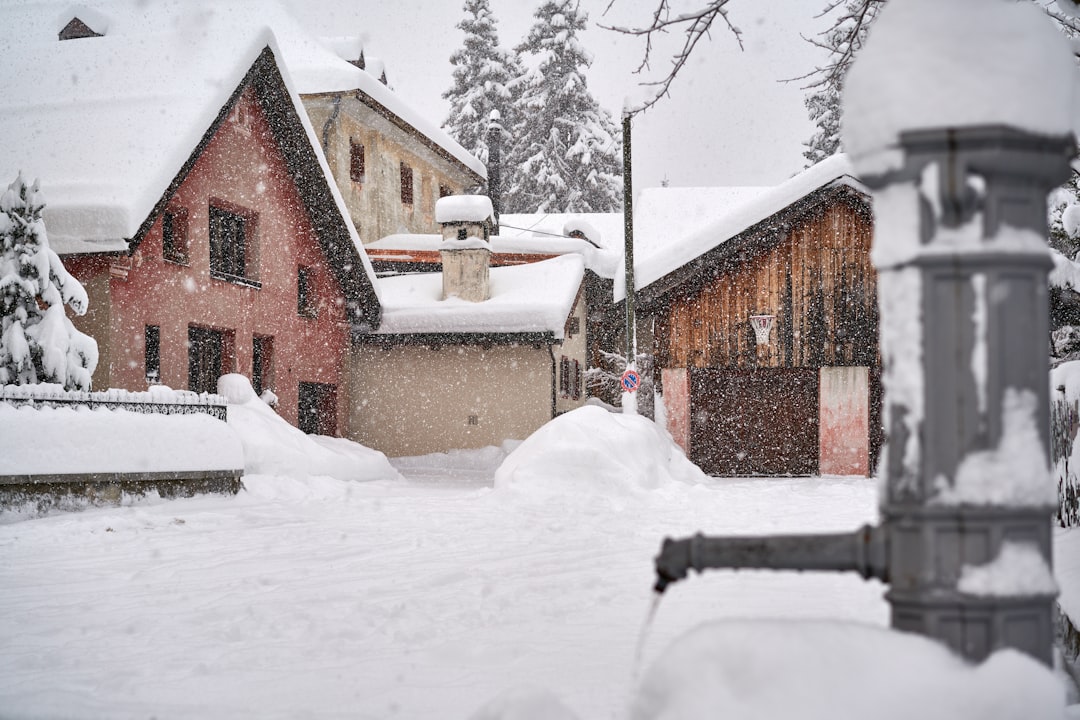 brown brick house covered with snow