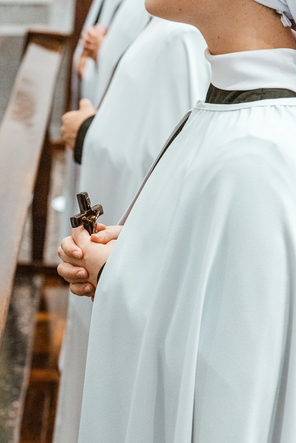 person in white dress shirt holding black and silver tool