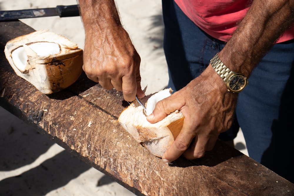 person in blue shirt holding bread