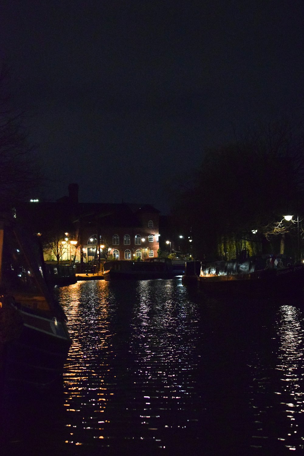 black boat on body of water during night time