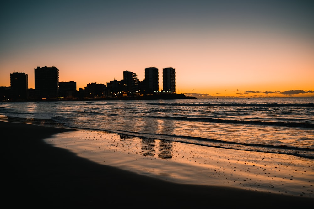 a beach with a city in the background