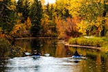 person riding on boat on river during daytime