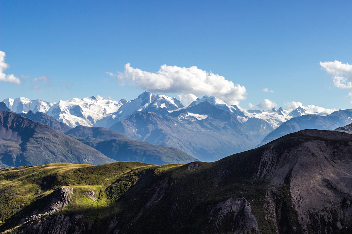 The snowy Bernina range seen from the slopes above Zuoz in summer