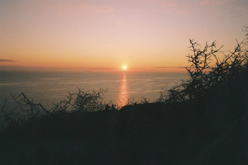 A captivating frame featuring a sunset over a calm ocean horizon.