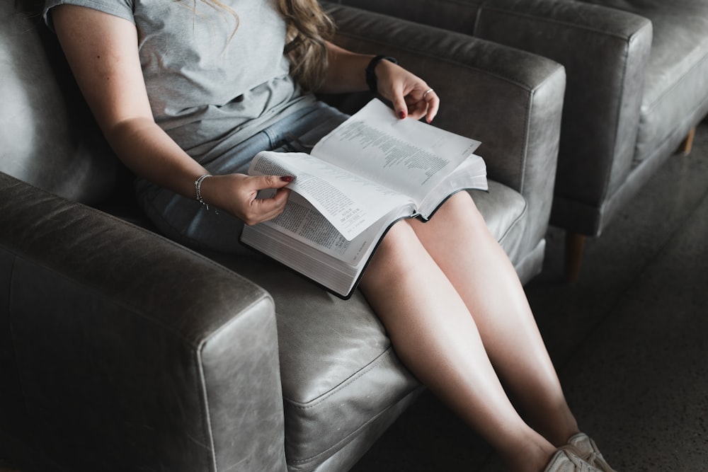 woman in white shirt reading book