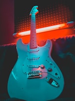 white and brown stratocaster electric guitar