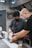 a couple of men in a kitchen preparing food