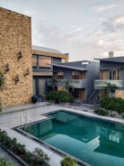 brown concrete building near swimming pool during daytime