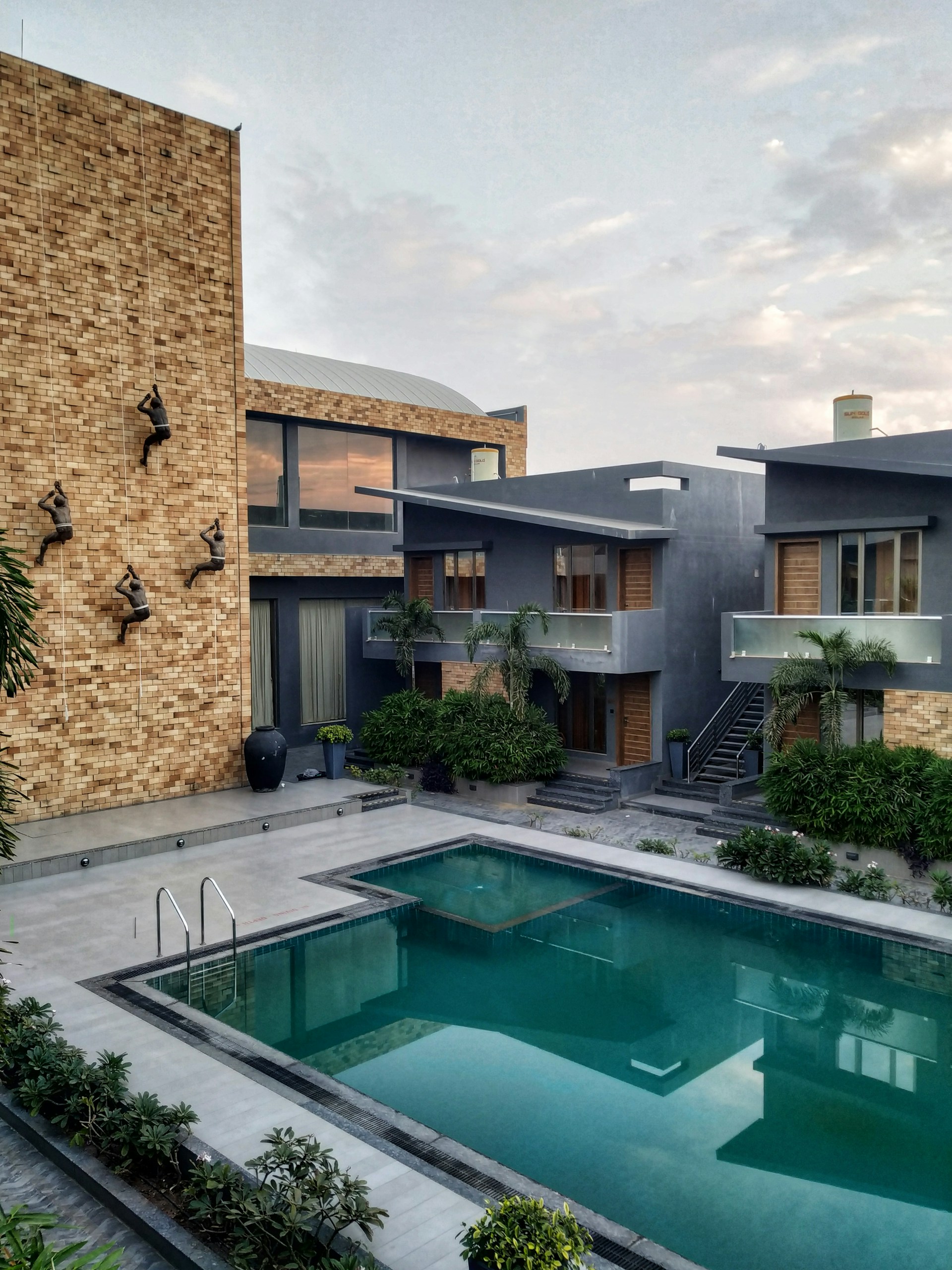 brown concrete building near swimming pool during daytime