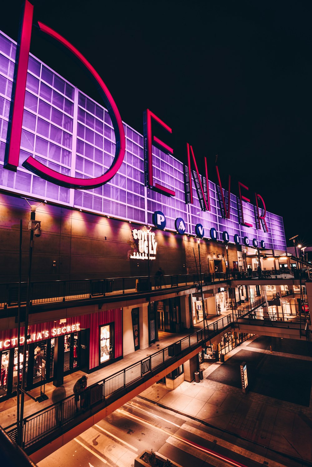 a large building with a lit up sign on the side of it