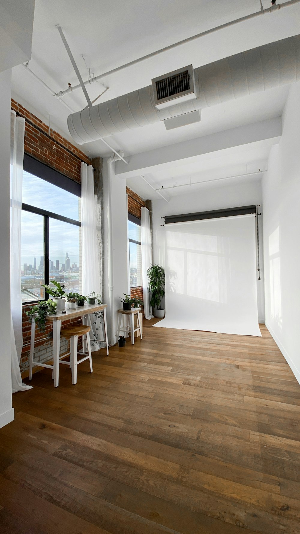 brown wooden table near window