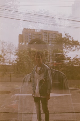 A layered image showing a person walking on a city street overlaid with translucent digital map lines and audio waveforms.