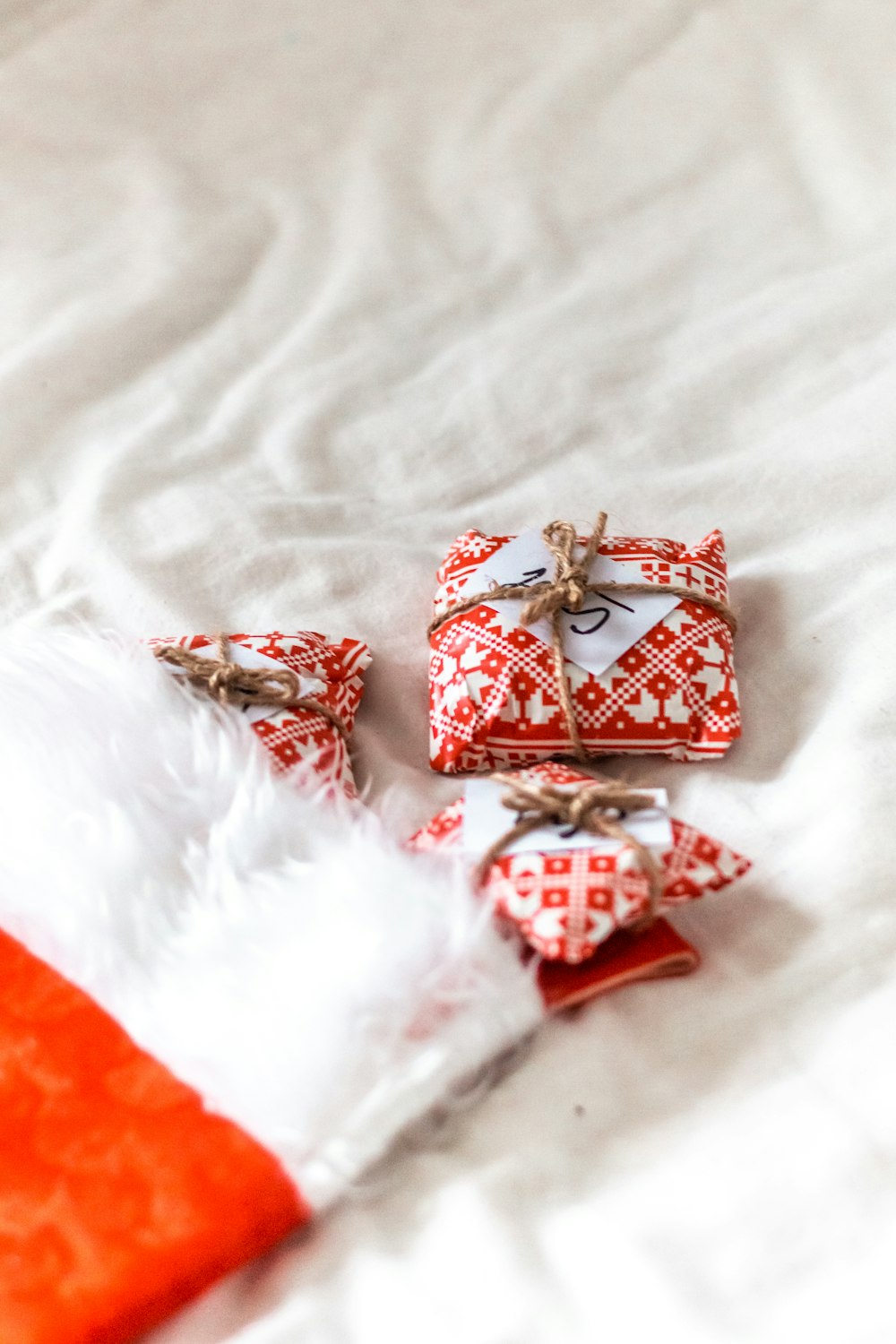 red and gold gift box on white textile