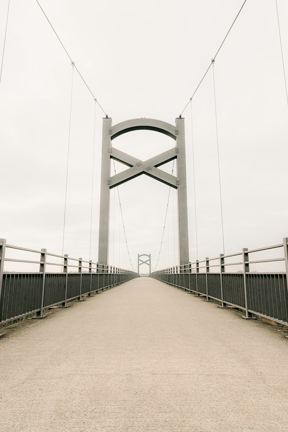 gray metal bridge under white sky during daytime