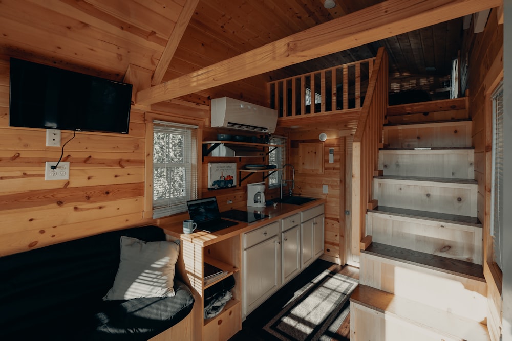 black flat screen tv on brown wooden tv rack