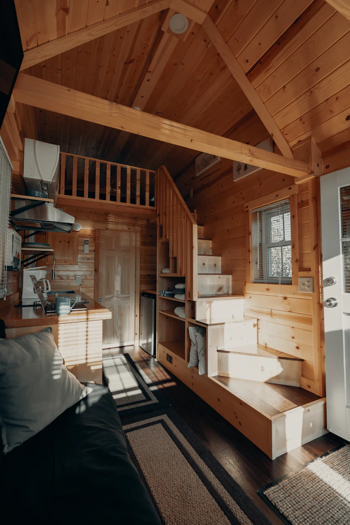 Kitchen area inside a luxury tiny home with wood cabinetry