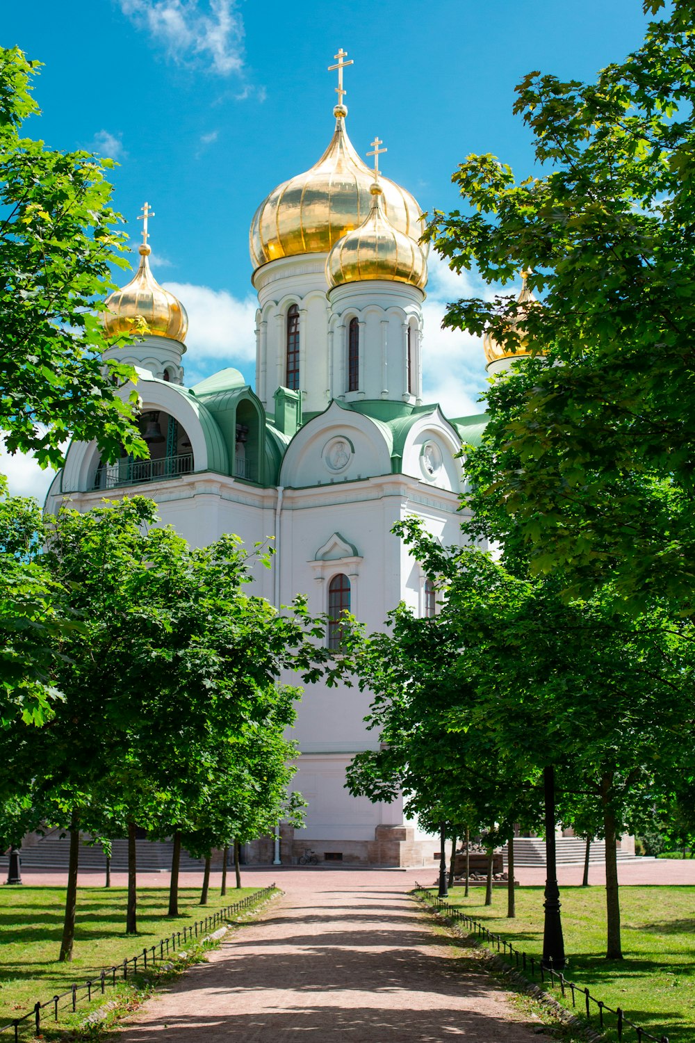 a large white building with gold domes on top of it