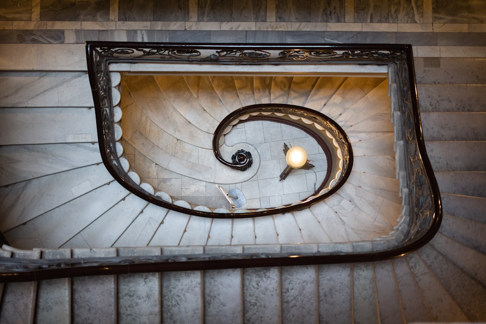 brown spiral staircase with light fixture