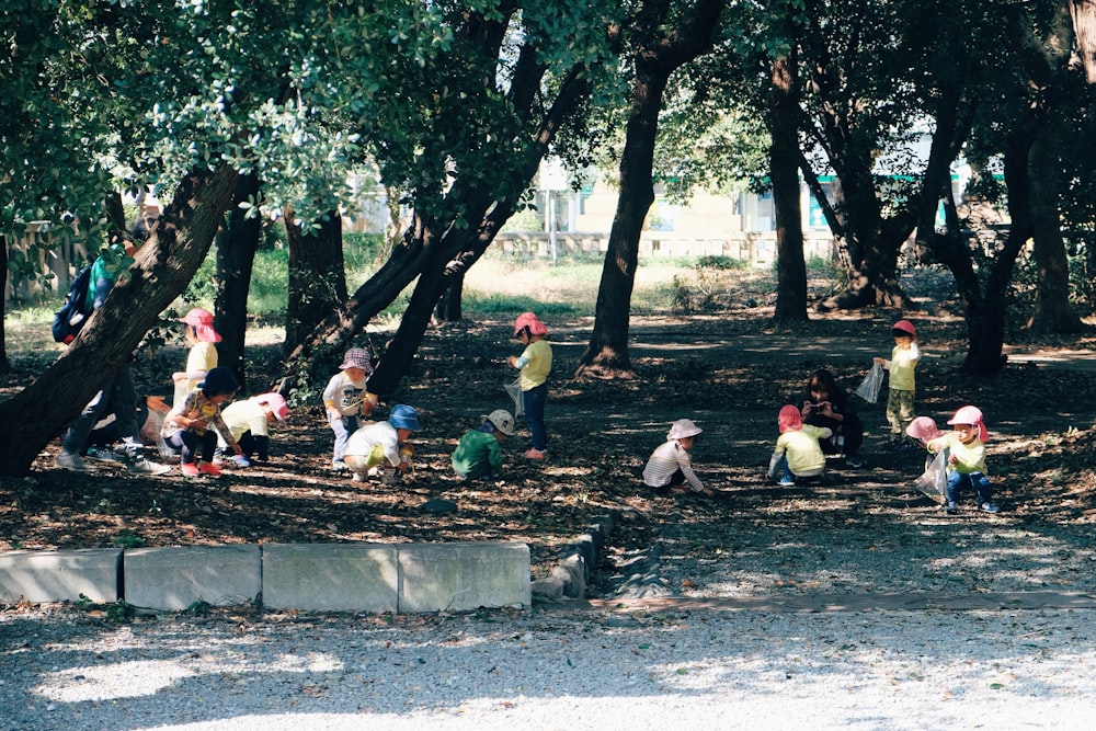 people sitting on concrete bench near trees during daytime