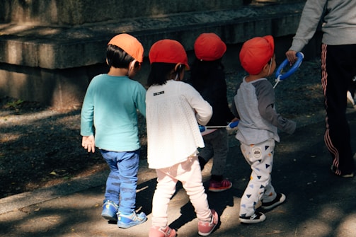 man in blue long sleeve shirt and white pants standing beside girl in white long sleeve