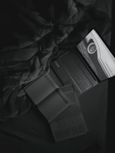 An open laptop displaying data privacy graphics, surrounded by books on artificial intelligence.