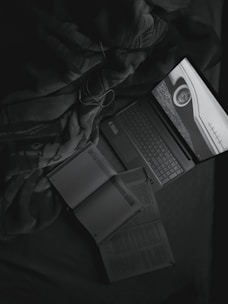 An open laptop displaying data privacy graphics, surrounded by books on artificial intelligence.