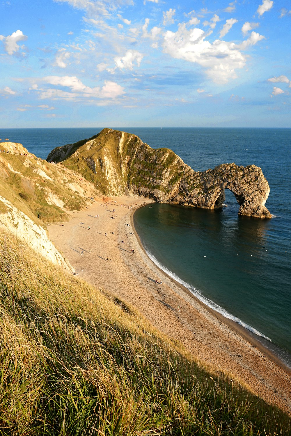 brown sand beach with blue sea during daytime