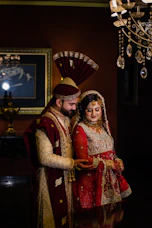 Elegant wedding collection featuring a groom in a richly embroidered kurta with matching silk dhoti, set against a royal backdrop.
