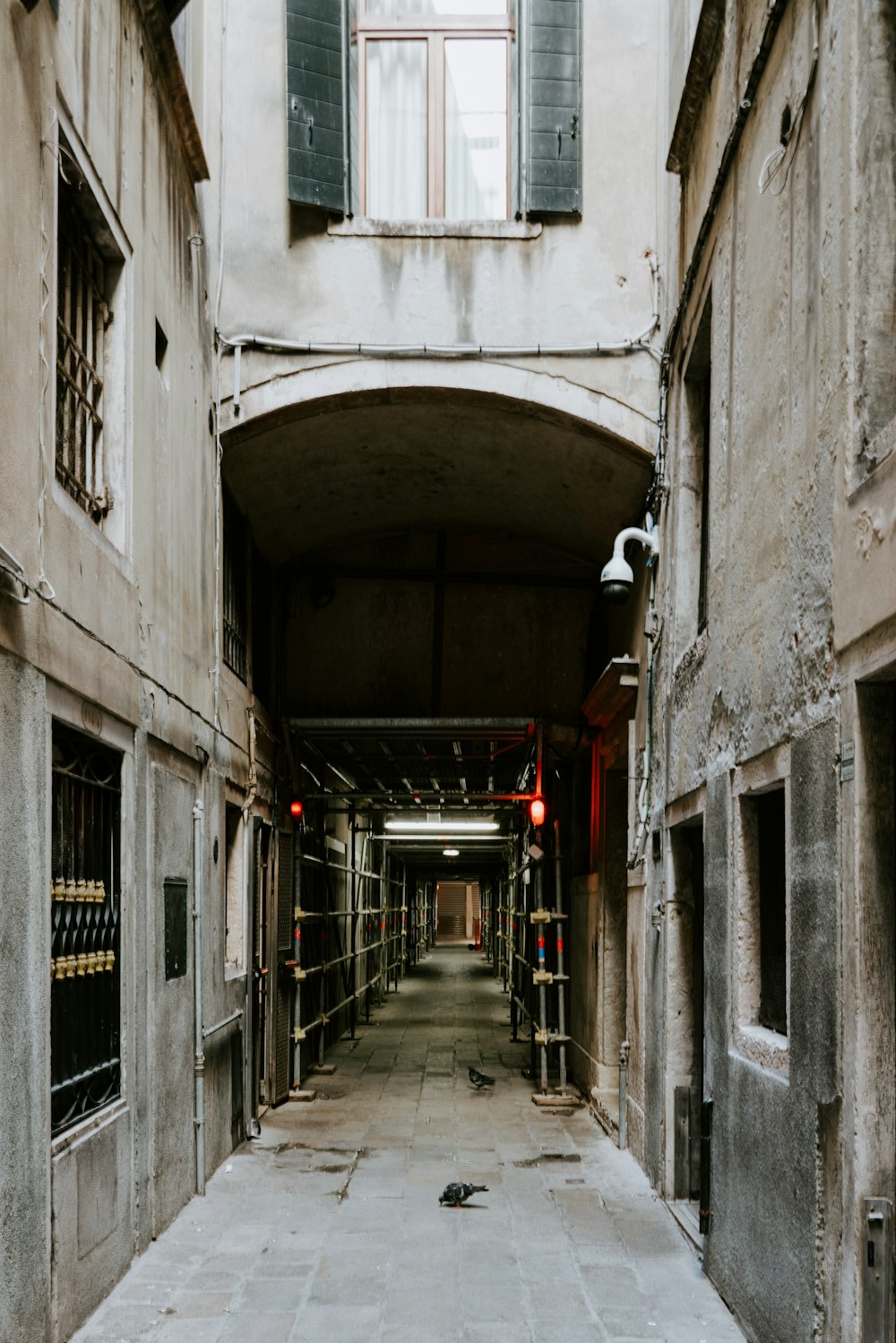 empty hallway with red lights on during daytime