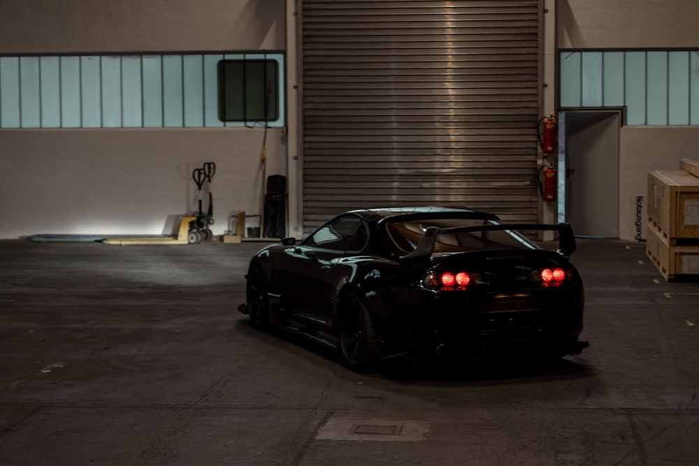 black porsche 911 parked in garage