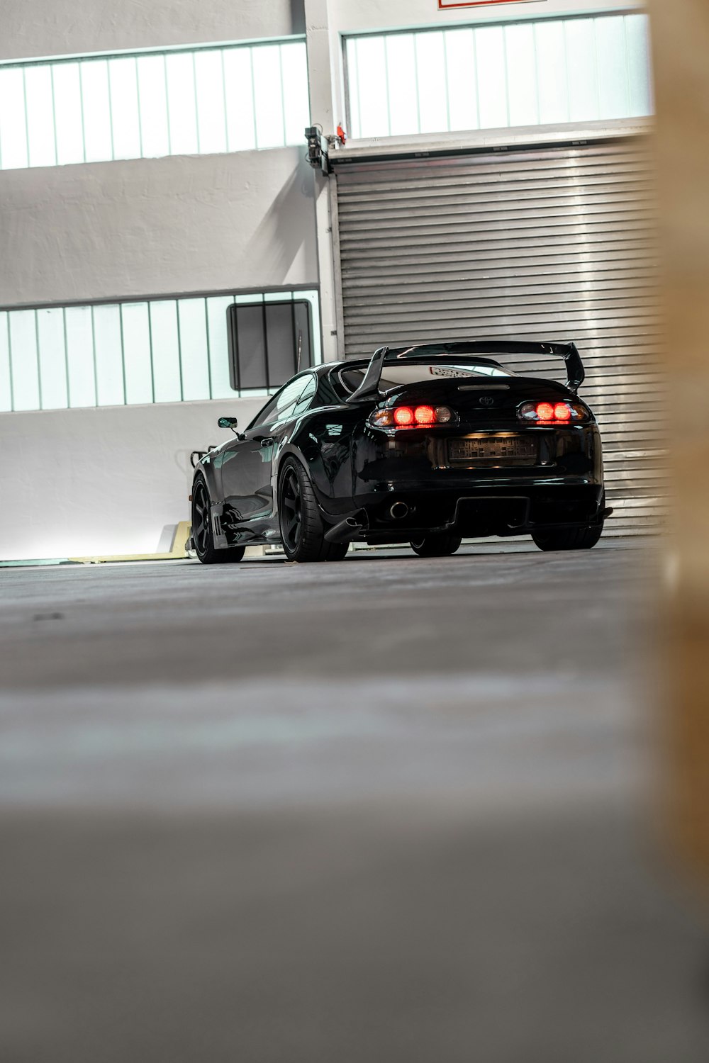 black porsche 911 parked in garage