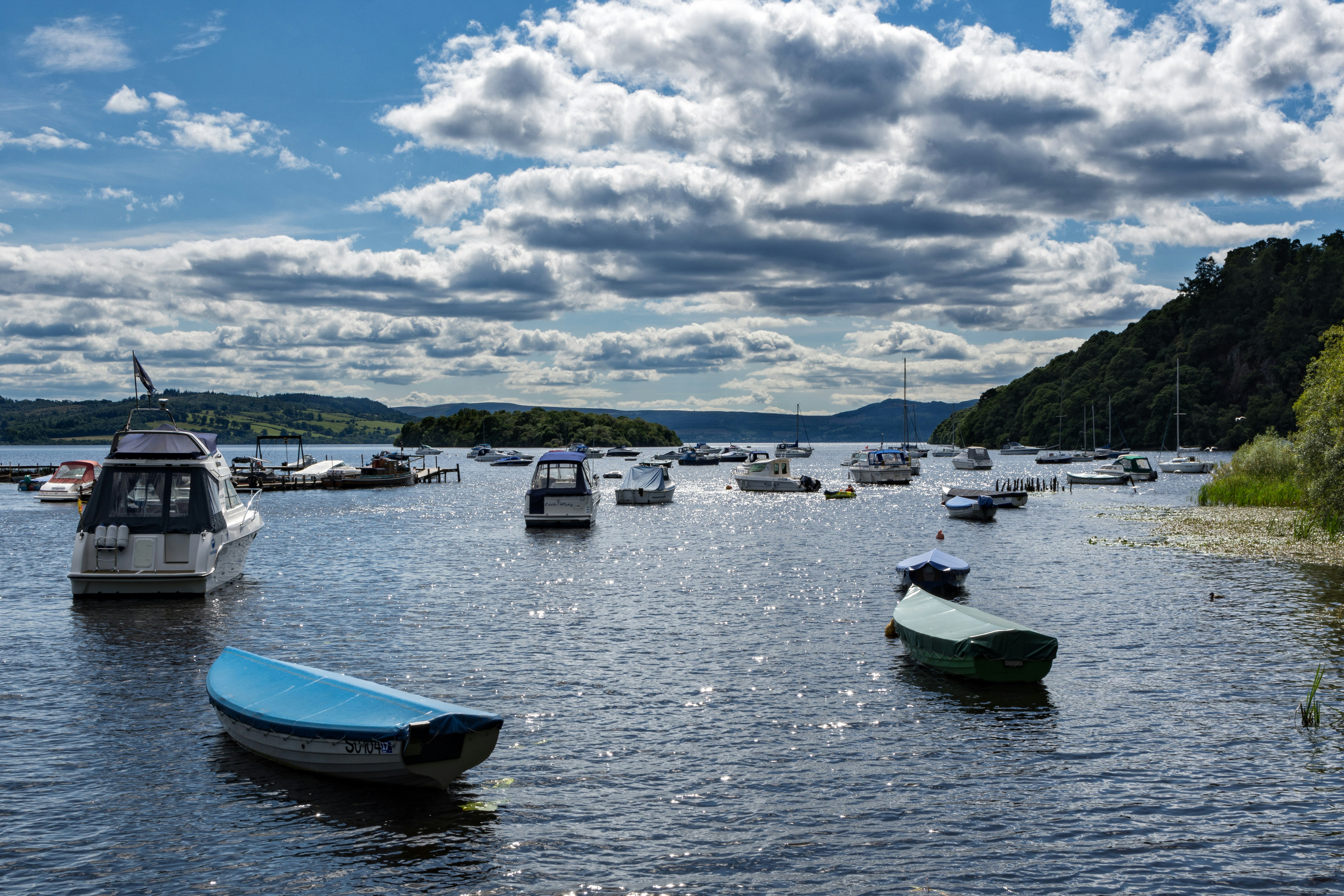 blue and white boat on sea under white clouds and blue sky during daytime, 