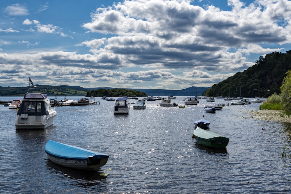 blue and white boat on sea under white clouds and blue sky during daytime