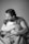 grayscale photo of woman in t-shirt carrying baby