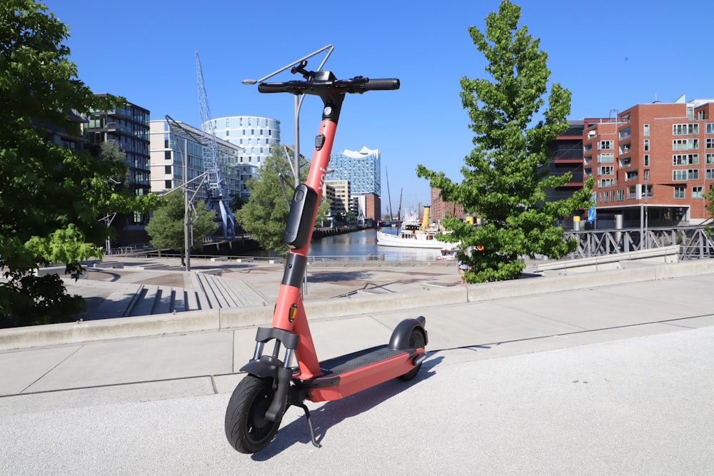 red and black bicycle on gray concrete road during daytime