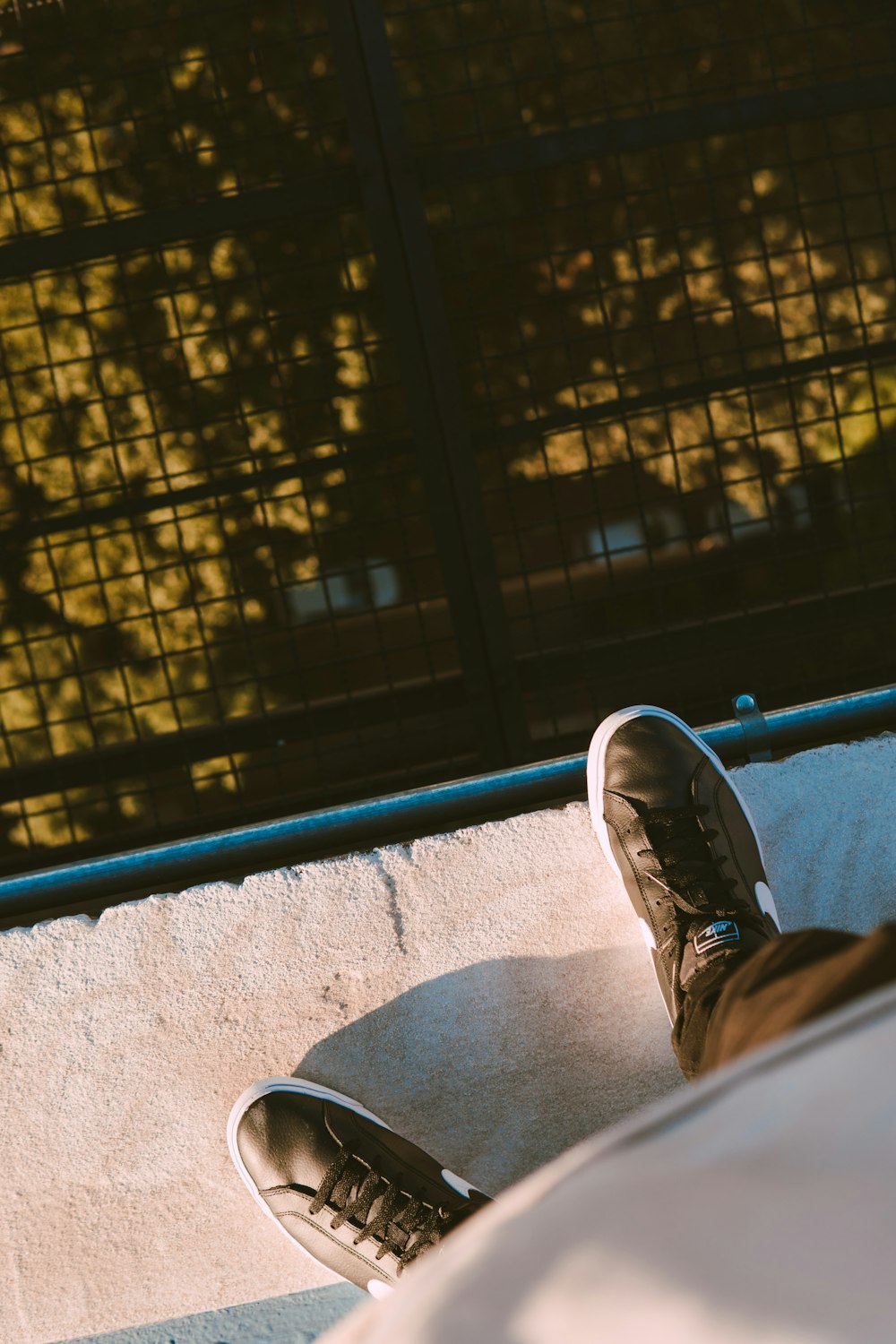 person in blue denim jeans and black sneakers