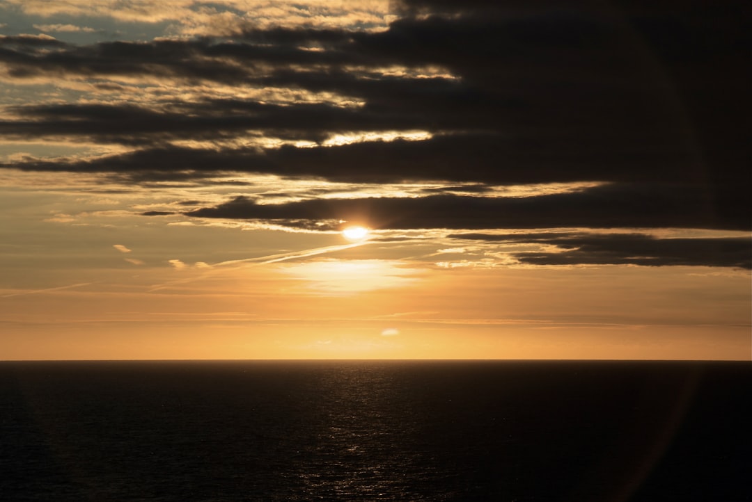 body of water during sunset