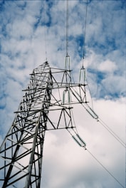 gray metal tower under white clouds