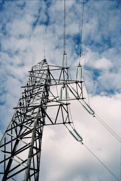 gray metal tower under white clouds
