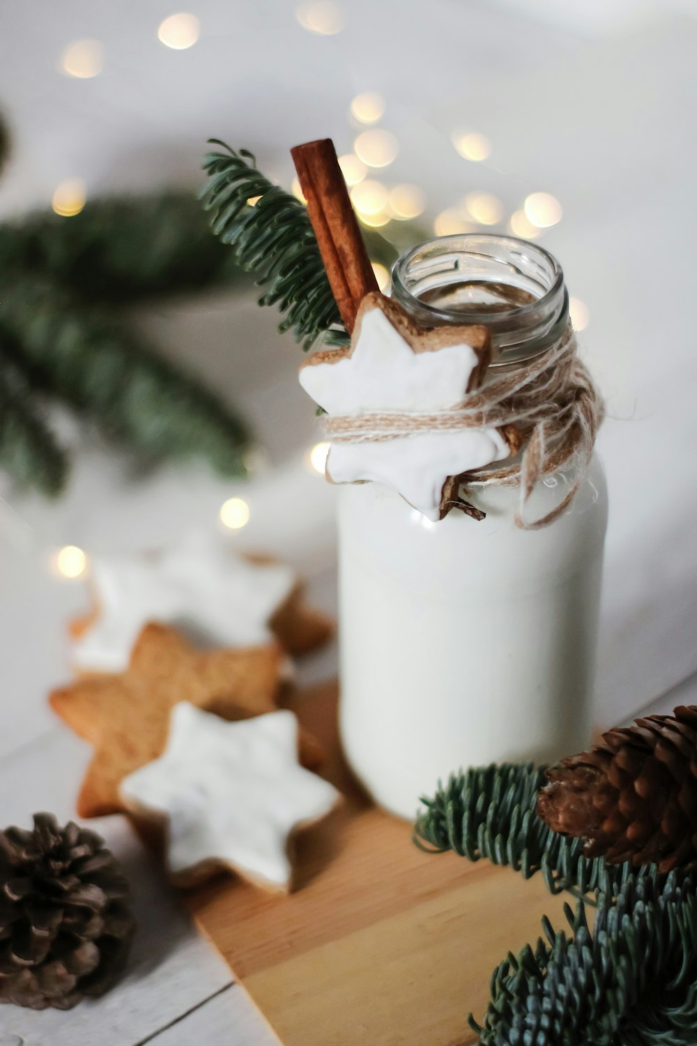 brown pine cone on white ceramic jar