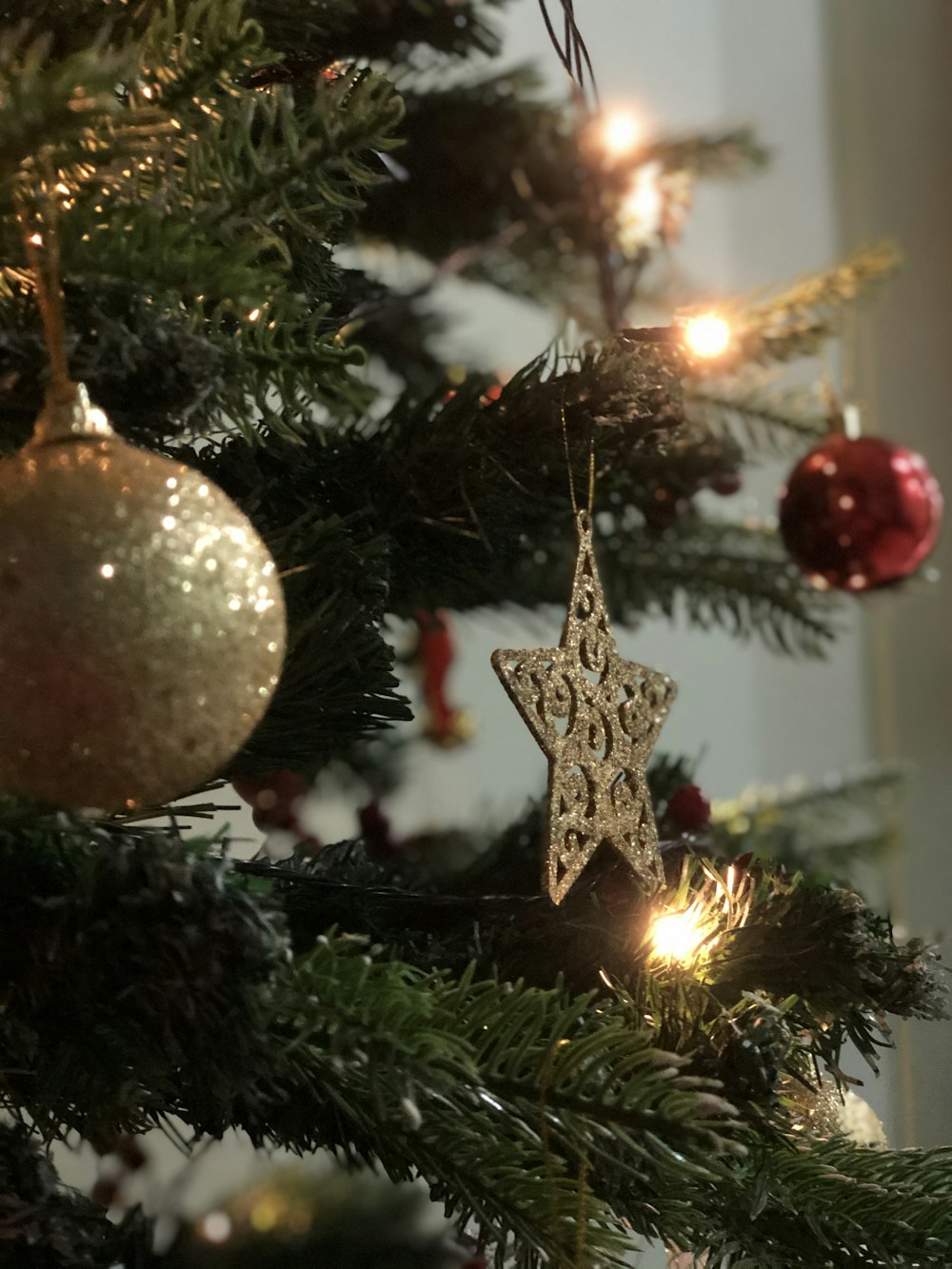 gold and red baubles on green christmas tree