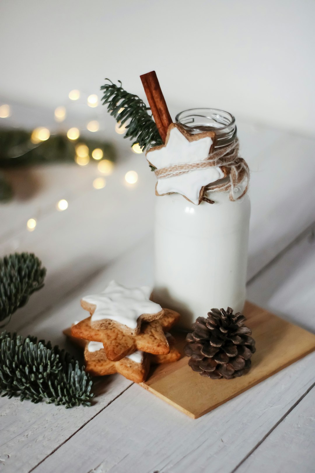 brown pine cone and white pillar candle