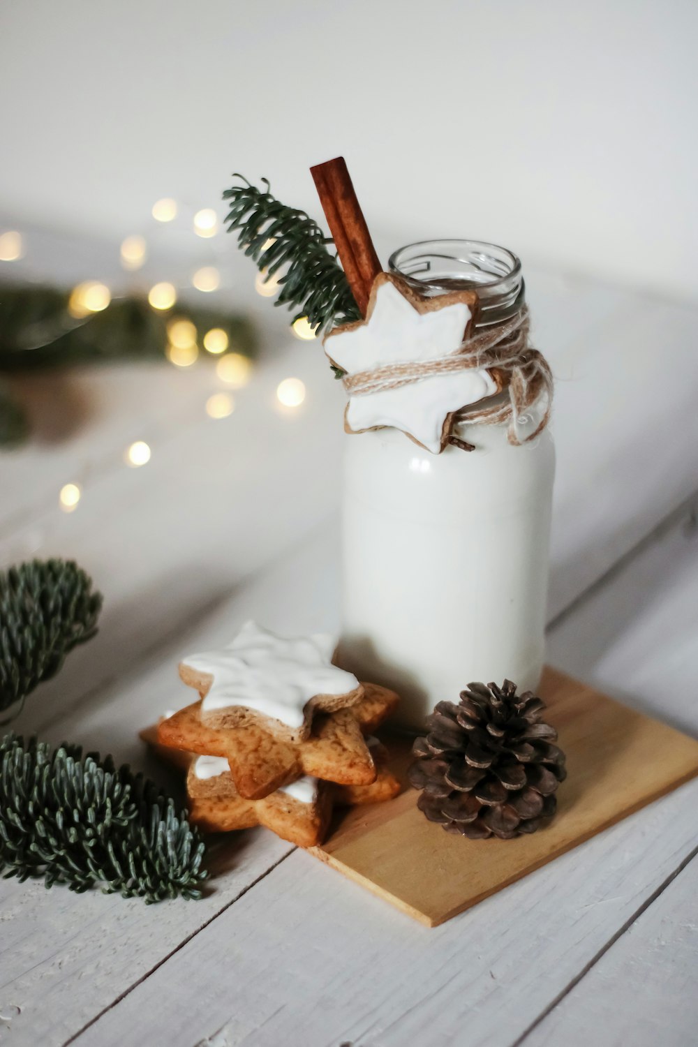 brown pine cone and white pillar candle